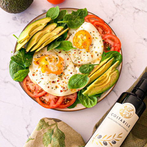 Poached eggs with avocado tomato and extra virgin olive oil